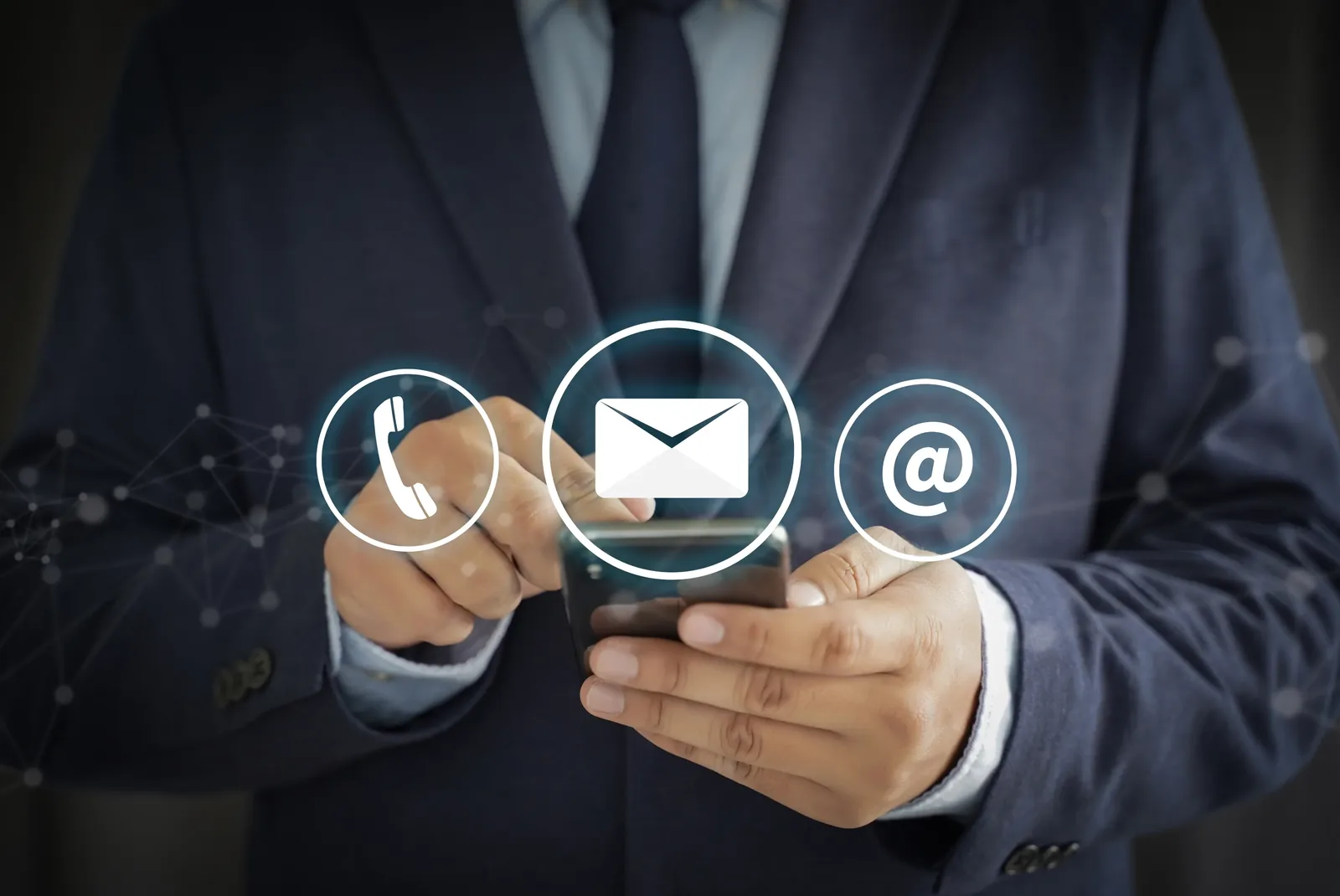 A person holding a phone with call, message and email icons, representing ways to get in touch